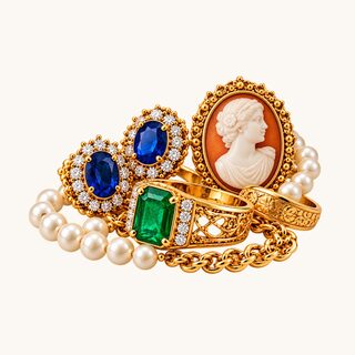 Estate jewelry including emerald ring, sapphire earrings, cameo, and pearls